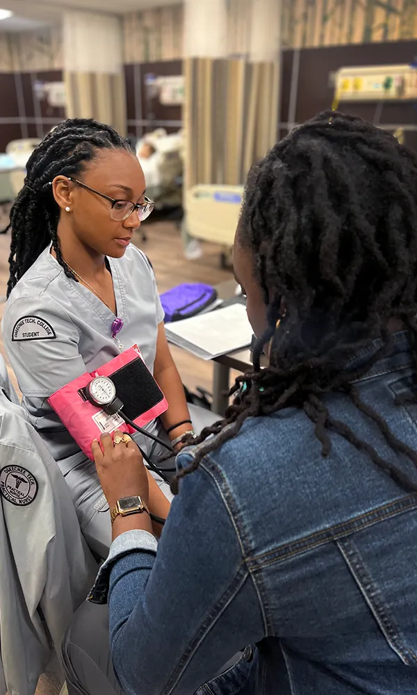 Nursing student taking blood pressure