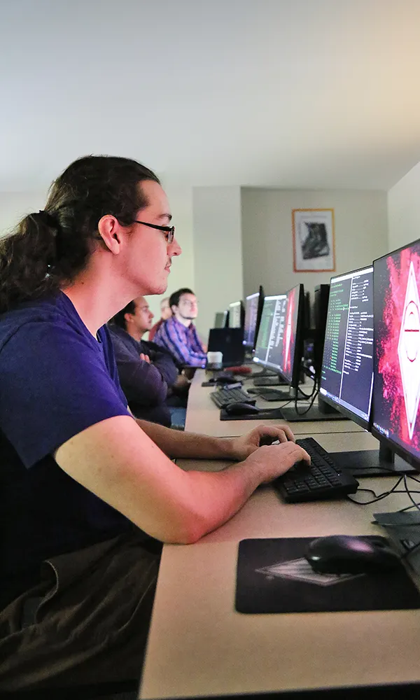 Cybersecurity student analyzing computer code