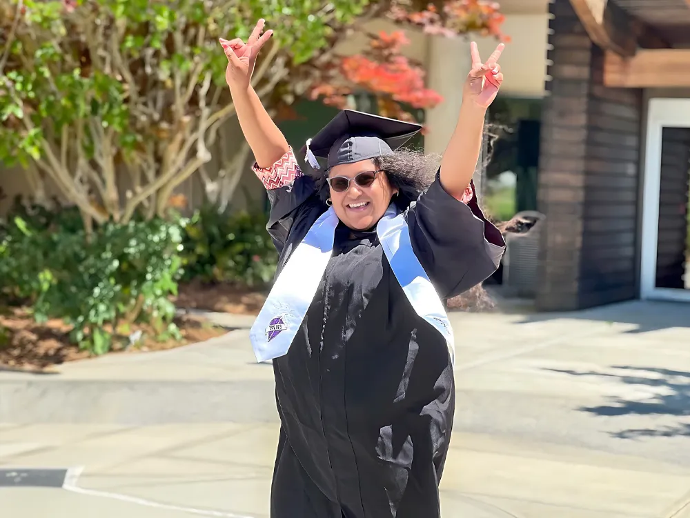 OTC STudent with hands in air smiling